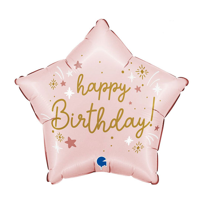 Light pink star-shaped balloon with gold writing saying happy birthday